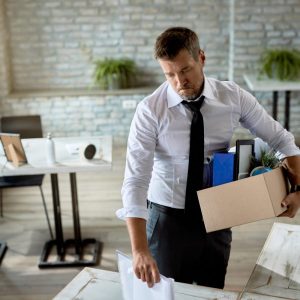 mid-adult-businessman-holding-his-belongings-feeling-sad-because-he-lost-his-job