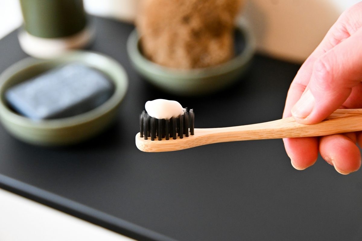 person holding a toothbrush with toothpaste