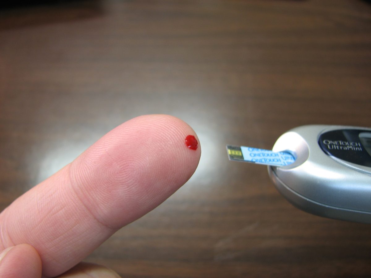 blood at the tip of finger after a diabetes prick