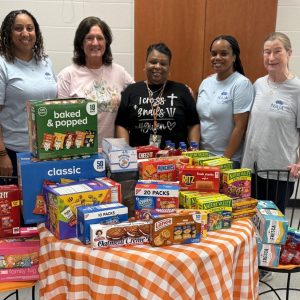 Junior Auxiliary restocks snack shelves for Clinton Success Center staff