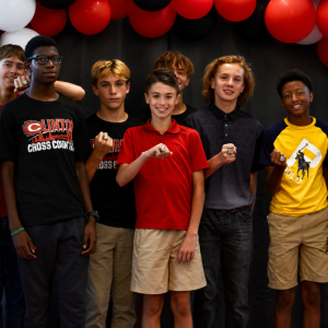 Pictured (l to r) are runners and coaches of the CJHS boys cross country team posing with their state championship rings during a ring ceremony held recently at Clinton High School.