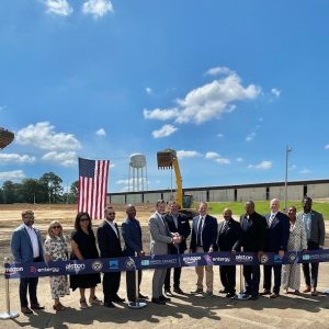 Clinton Mayor WIll Purdie joins AWS officials Roger Wehner to cut the ribbon at the data center site in Clinton as members of the Board of Aldermen and the Hinds Co. Supervisors watch.