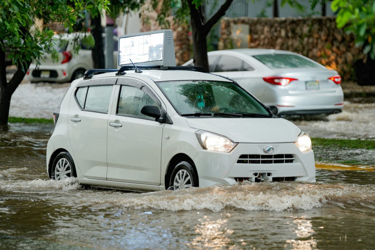 white car driving through the flooded street
