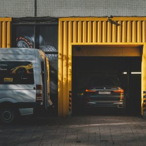 white van sitting out side of black and yellow building