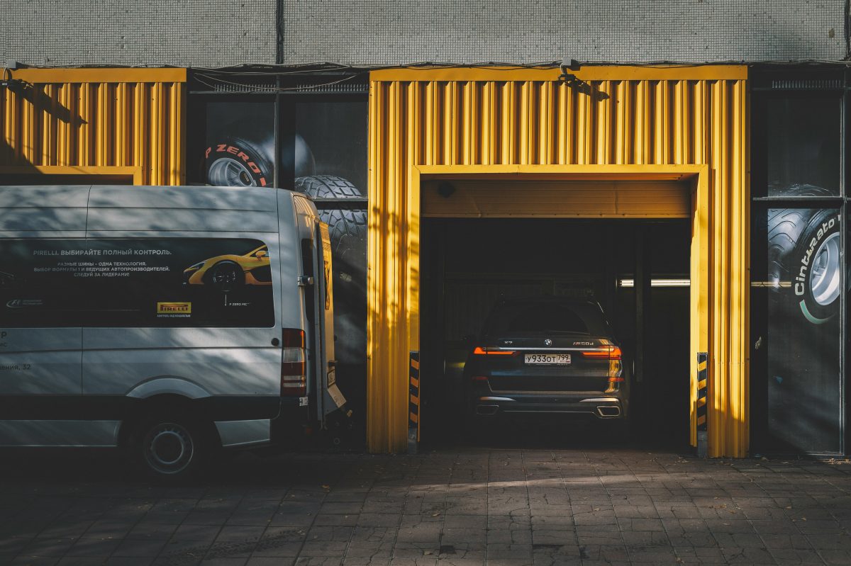 white van sitting out side of black and yellow building