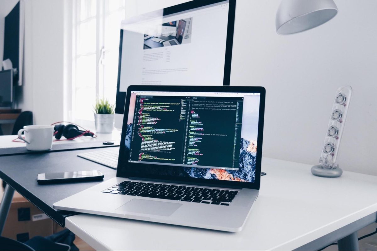 laptop sitting on a home desk showing code