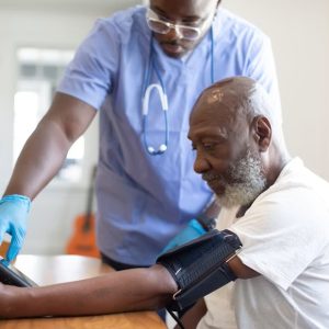man getting blood pressure checked at doctor