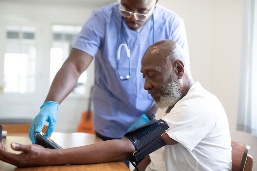 man getting blood pressure checked at doctor