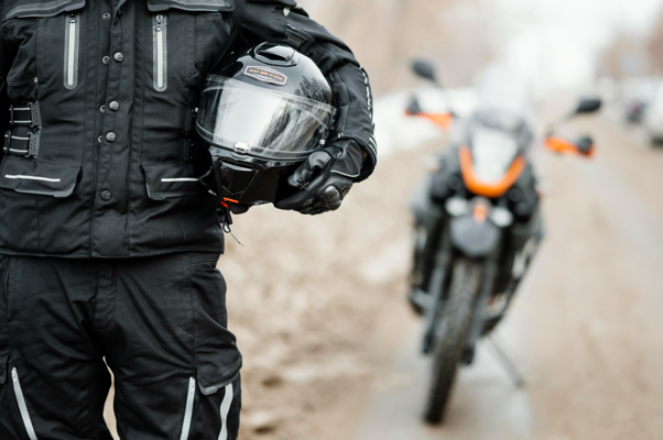 man holding a motorcycle helmet