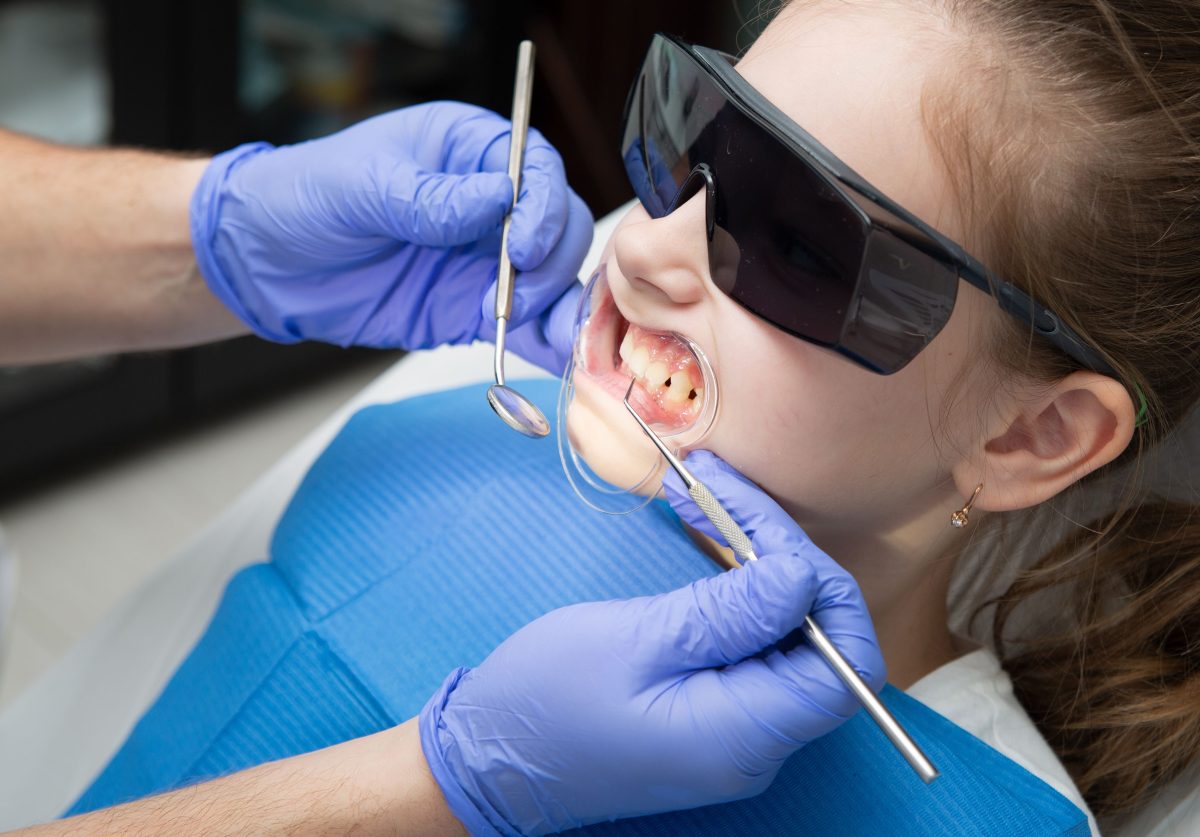 child getting teeth cleaned at dentist