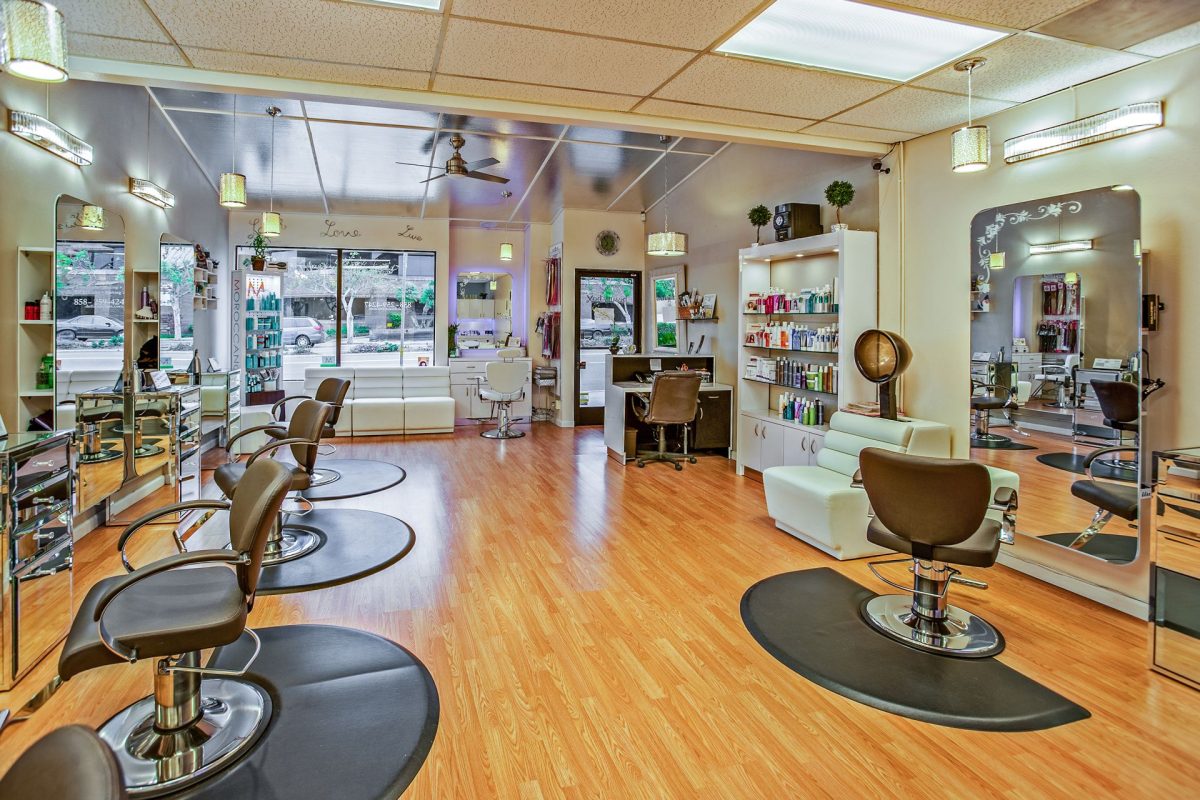 brown and white chairs sitting empty in hair salon
