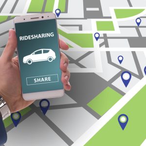 man holding a phone with rideshare above a map