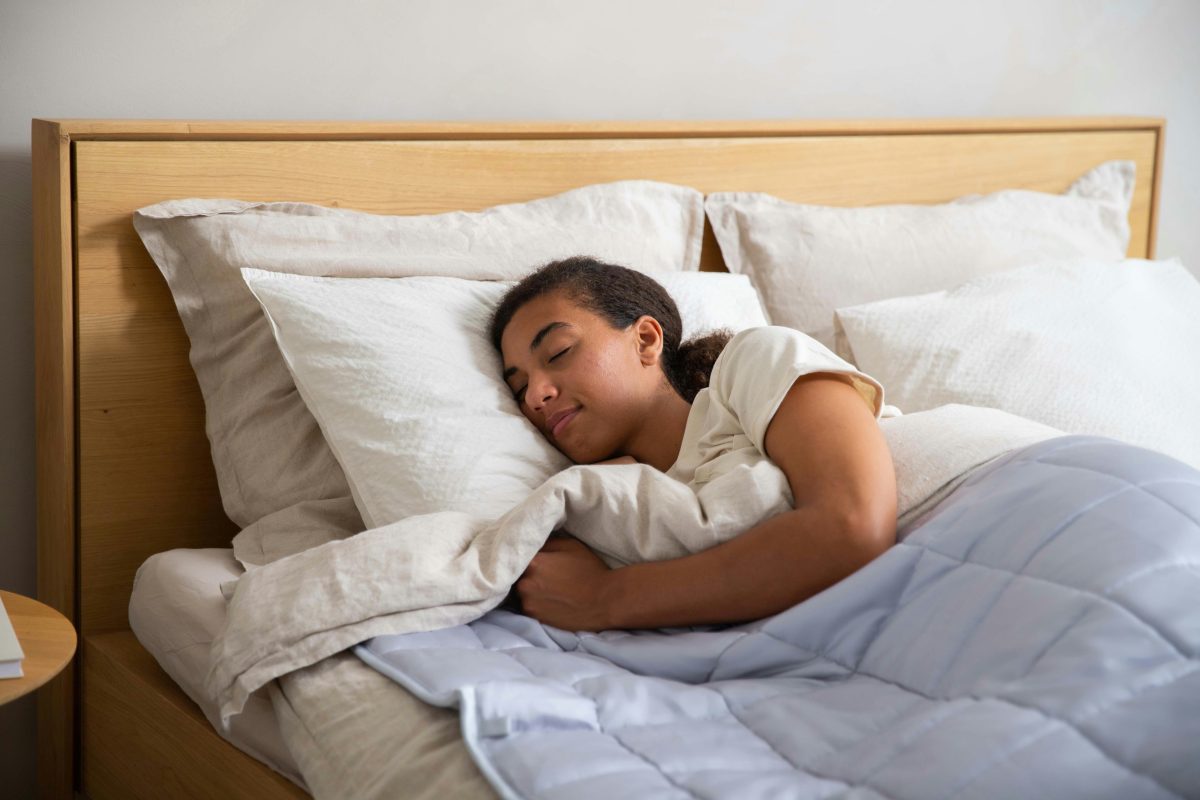 young girl sleeping in a bed with white sheets