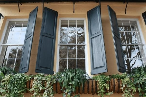 yellow house with black window shutters