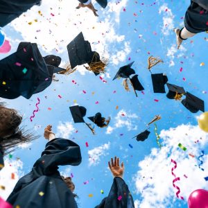 graduates throwing their hats in the air