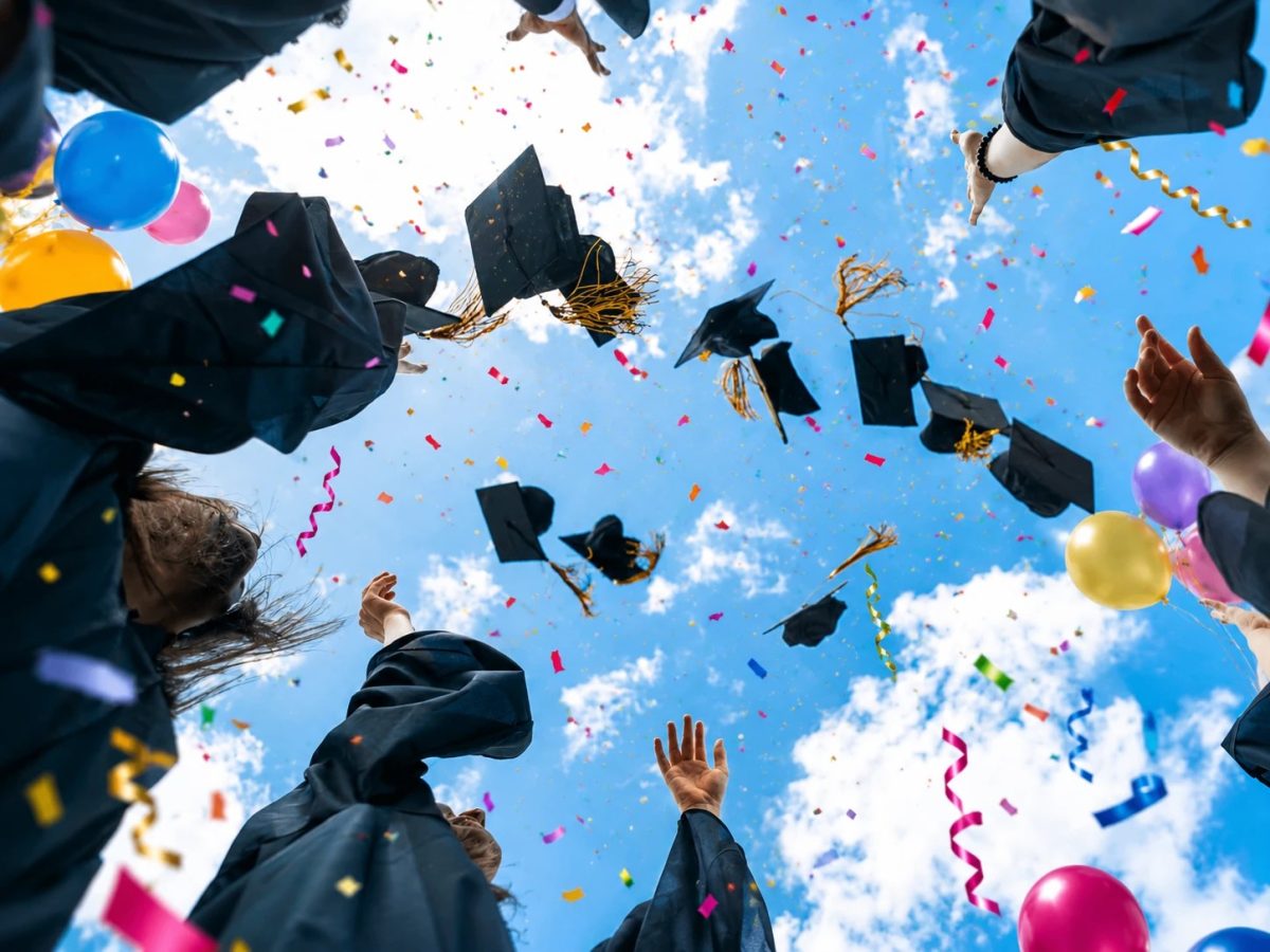 graduates throwing their hats in the air