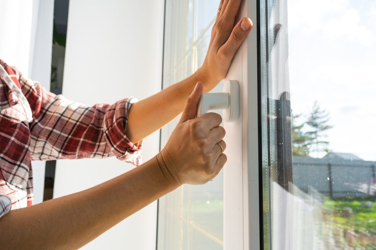 hand holding a window handle