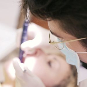 male dentist working in patient's mouth
