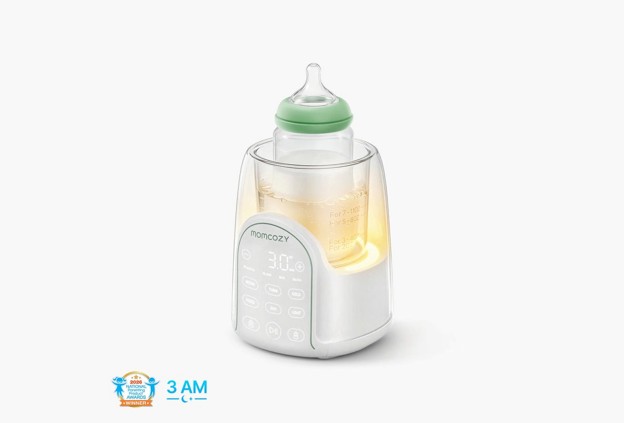 baby bottle sitting in a momcozy breastmilk warmer