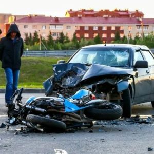 car wreck with wrecked motorcycle on roadway