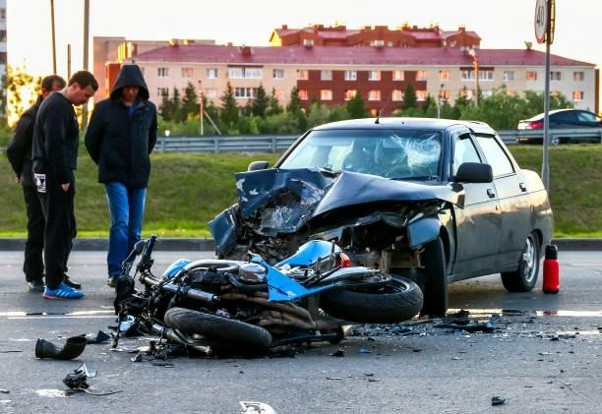 car wreck with wrecked motorcycle on roadway