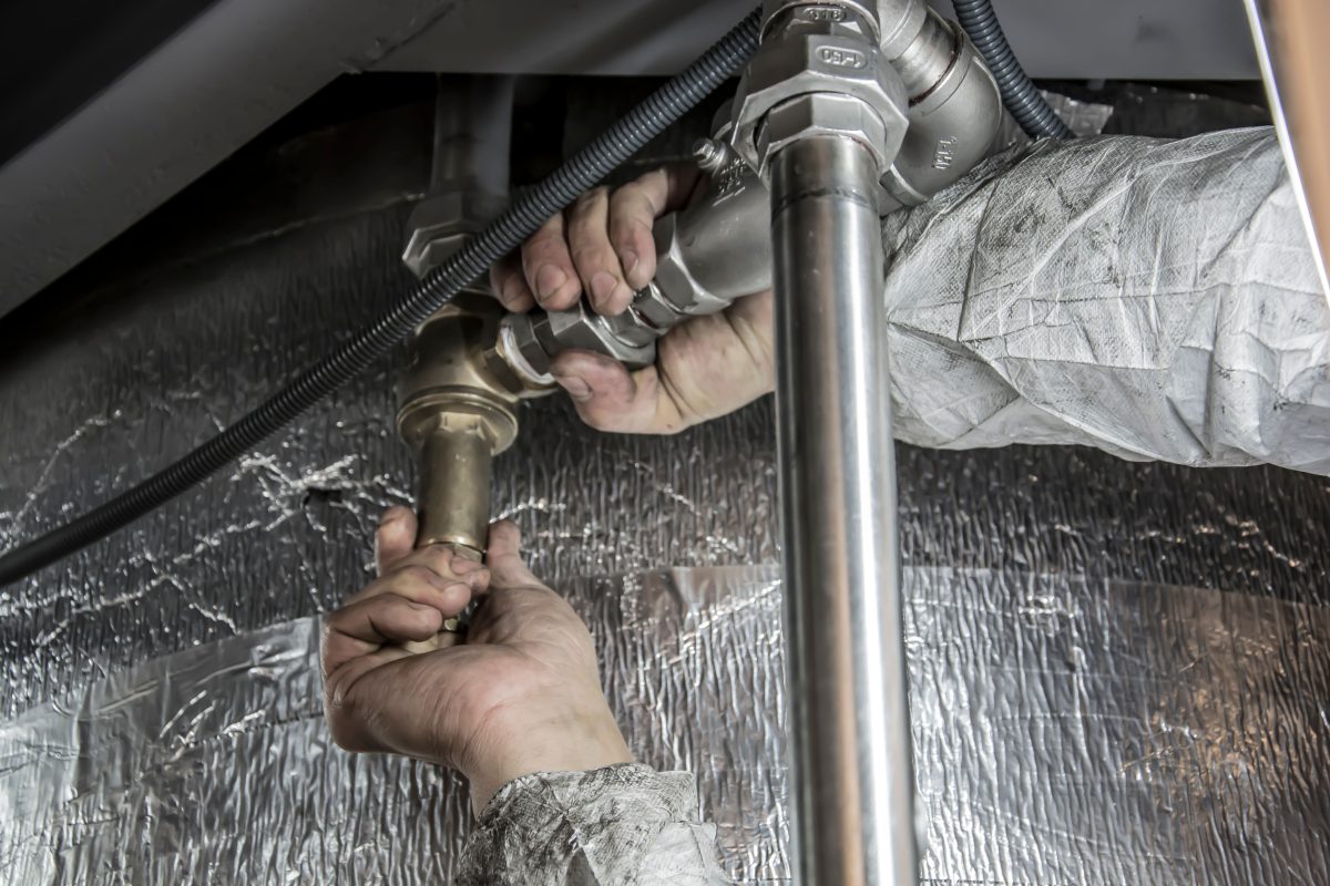 close up of plumber fixing pipes
