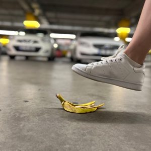 close up of a foot about to step ona banana peeling on the floor
