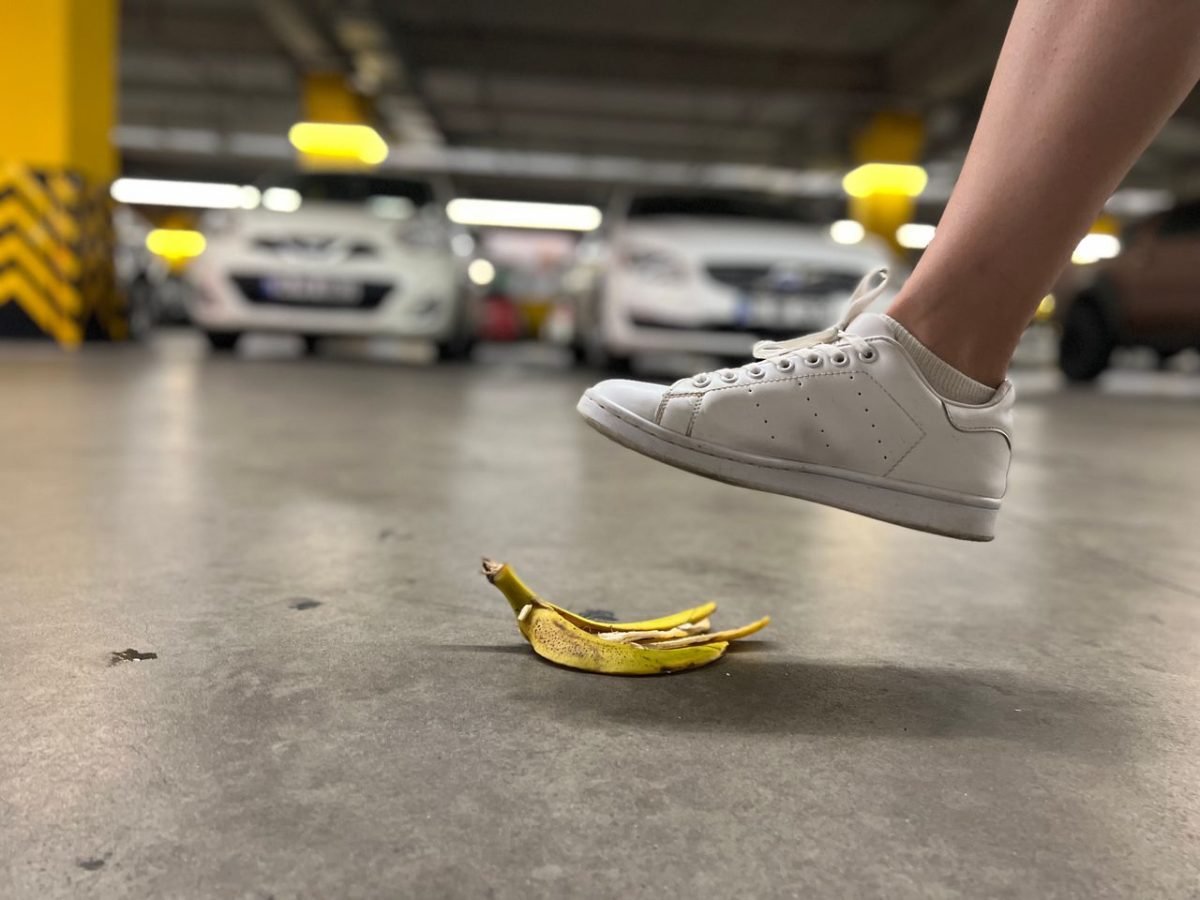 close up of a foot about to step ona banana peeling on the floor