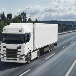 white 18 wheeler truck driving on open road