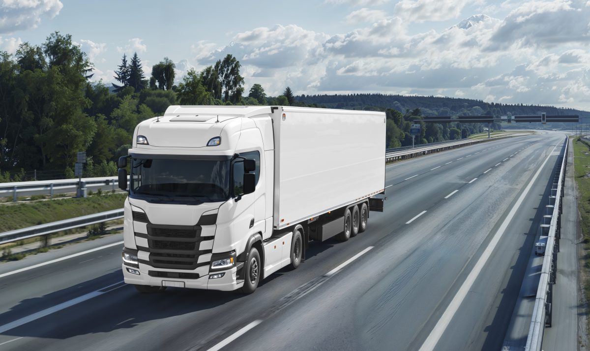 white 18 wheeler truck driving on open road