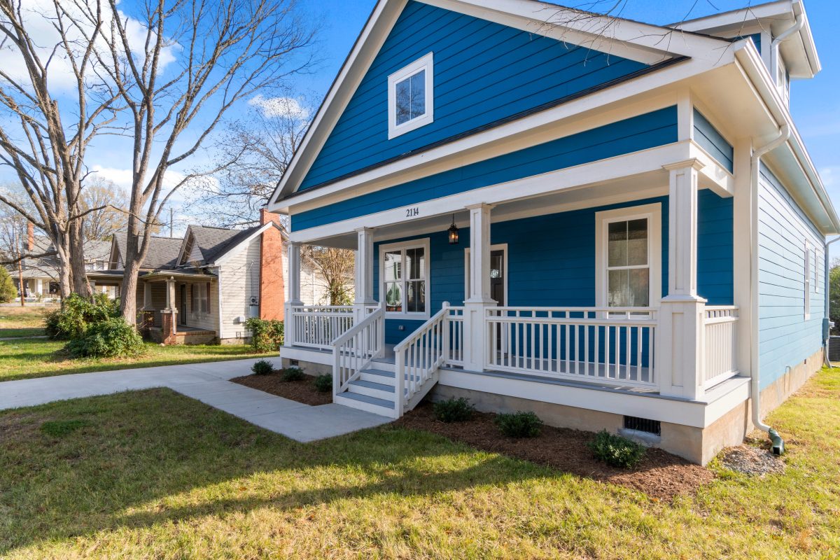 blue house with sidewalk