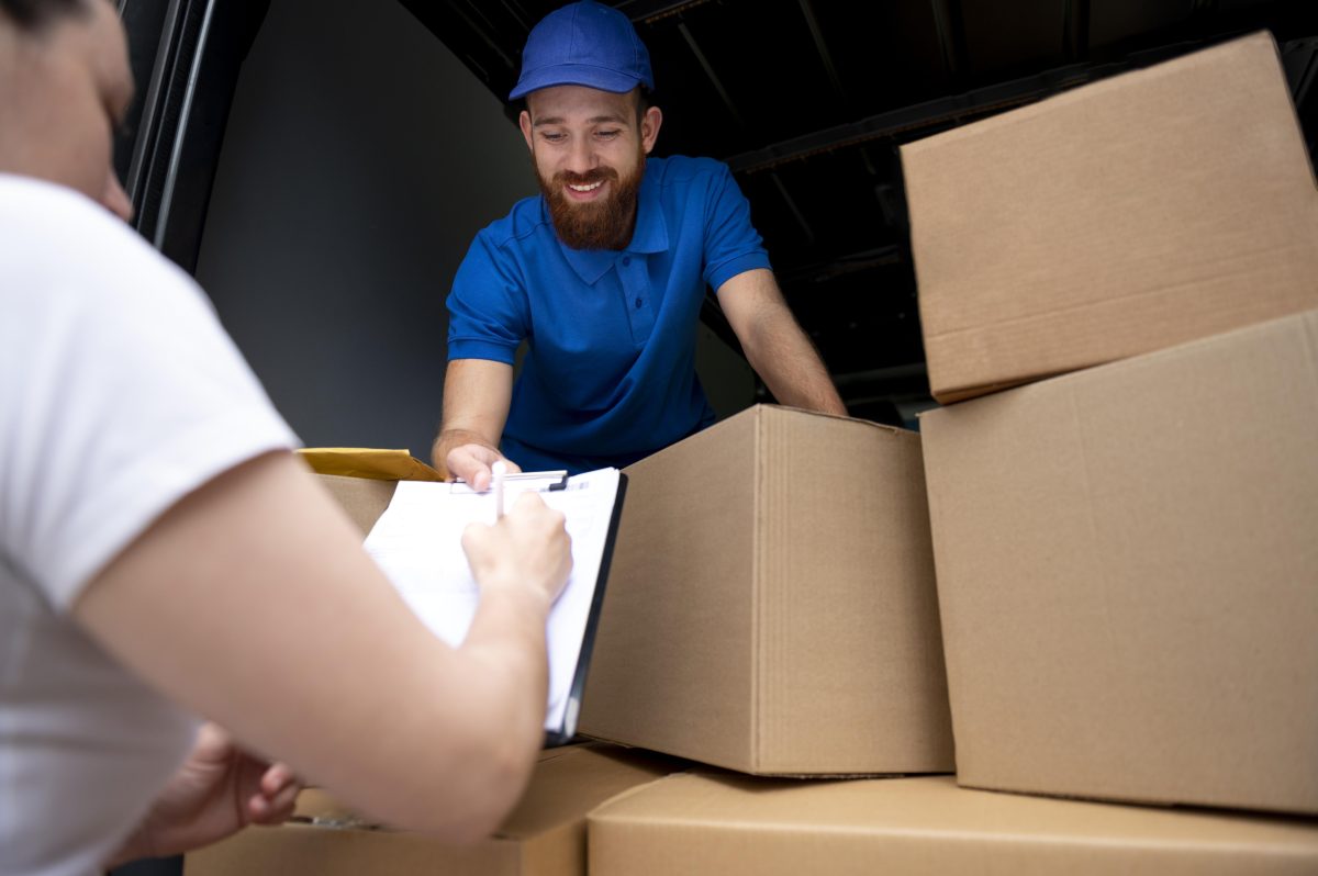 Close up delivery man with boxes