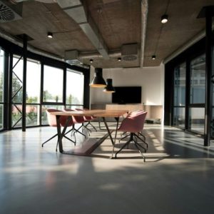 conference room table in room with lots of windows