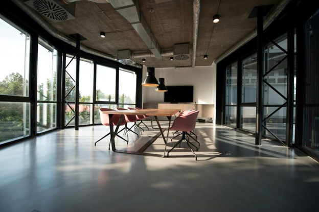 conference room table in room with lots of windows