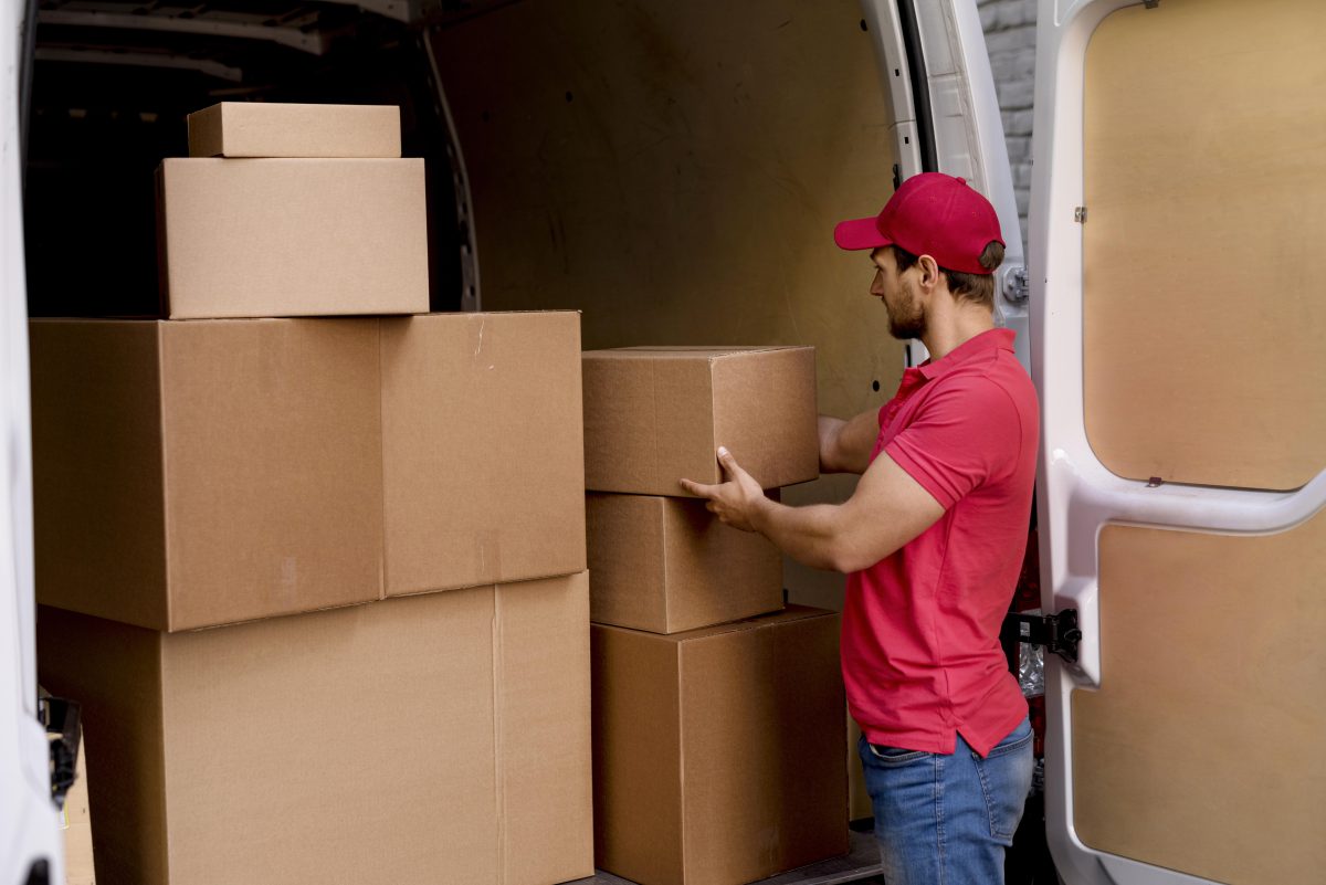  Delivery man at car taking packages