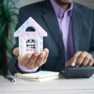 man holding tiny home