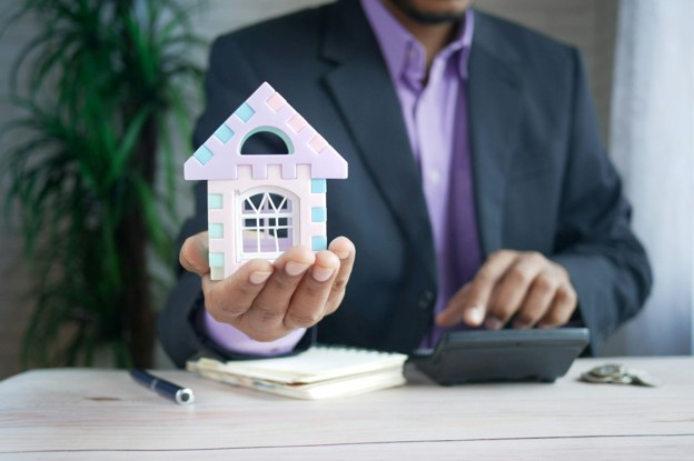 man holding tiny home