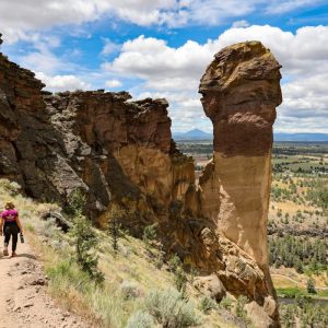 a person walking up a trail in the mountains