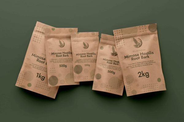 brown packages of mimosa hostilis root bark laying on green background