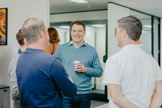 office staff standing talking