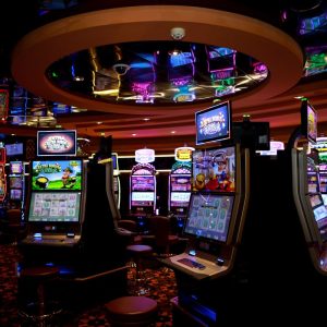 Vibrant casino floor with colorful slot machines and bright lights capturing a lively gaming atmosphere.
