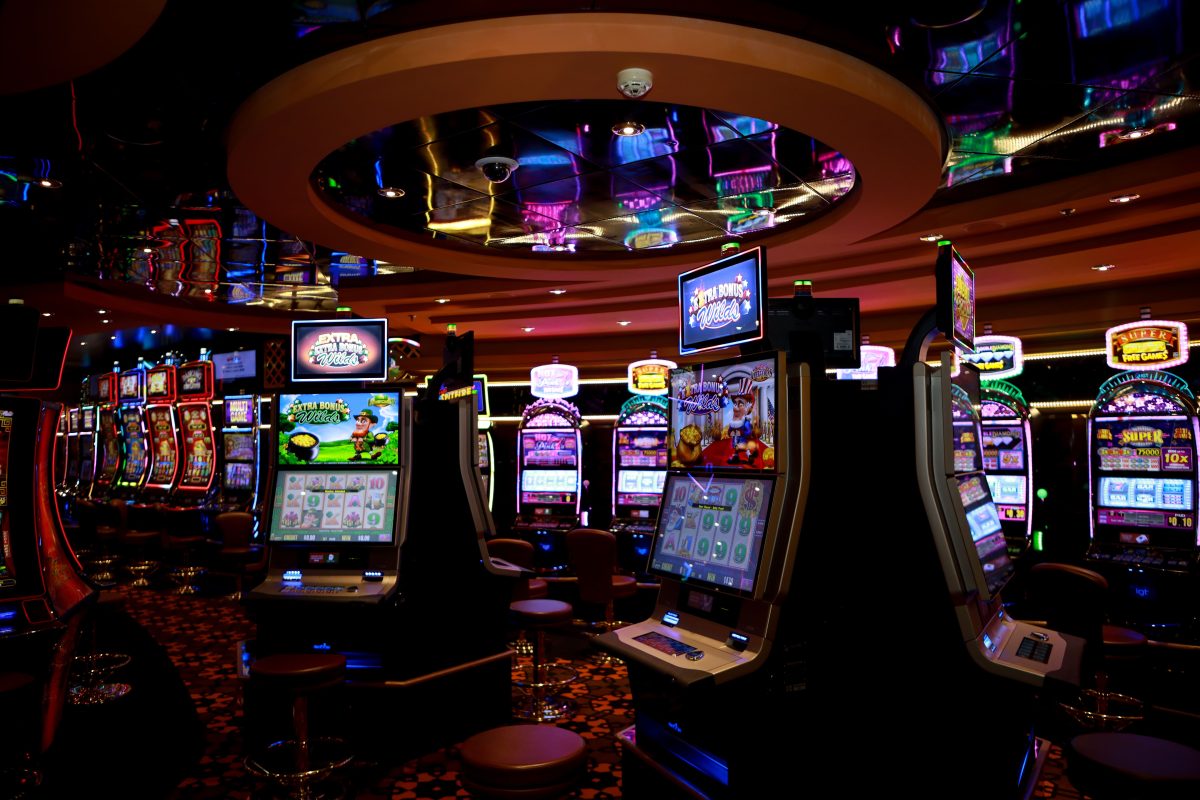 Vibrant casino floor with colorful slot machines and bright lights capturing a lively gaming atmosphere.
