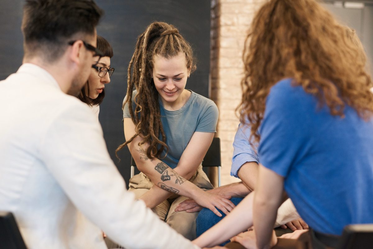 woman with dreads in a group rehab circle