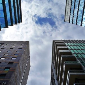 photo of tall buildings while looking up from the street