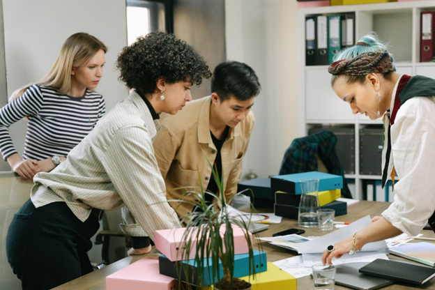 professional women in an office looking at paperwork on a desk