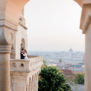 view-through-stone-arch-budapest-city-tiny-silhouette-couple-love in rome