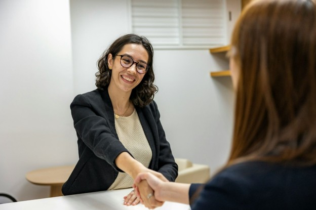woman shaking hands with a lender for loan