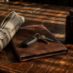 injury cast with keys and notebook on table