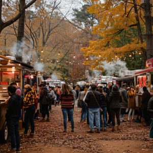 people on street eating street food at a fest