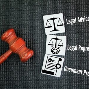 gavel on black table with legal images to the side